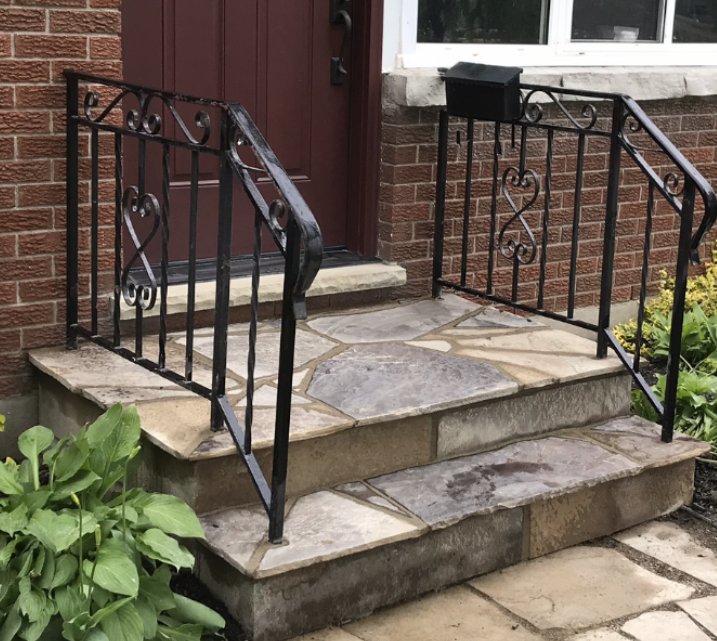 Restored front porch and steps with new dark stone tiles and clean grout lines after professional masonry work in London Ontario