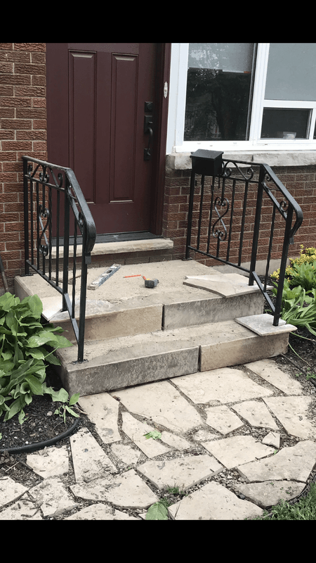 Workers removing damaged concrete from a residential porch and steps before restoration in London Ontario