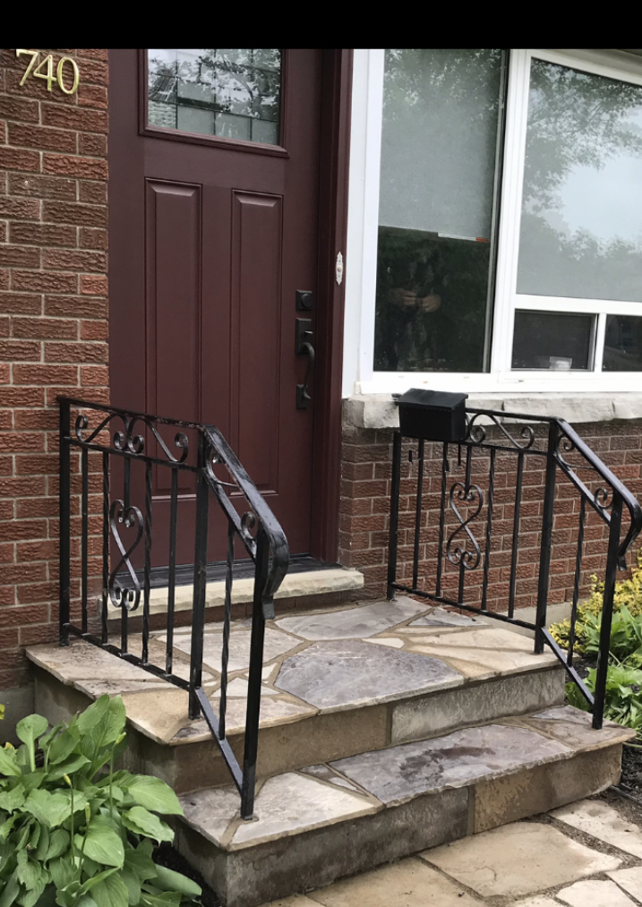 Workers removing damaged concrete from a residential porch and steps before restoration in London Ontario