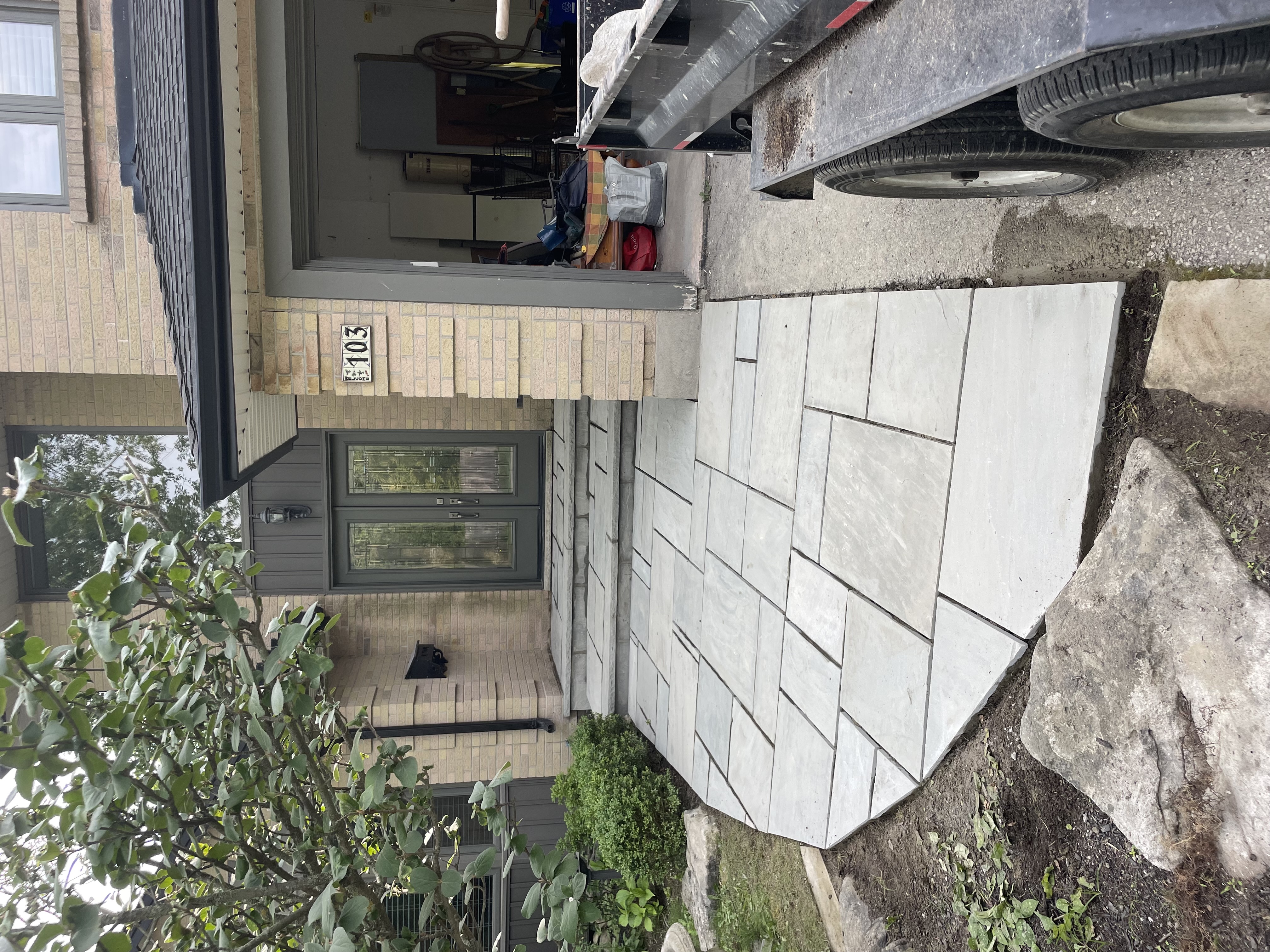 Restored front walkway and steps with new natural stone overlay in geometric pattern in London Ontario