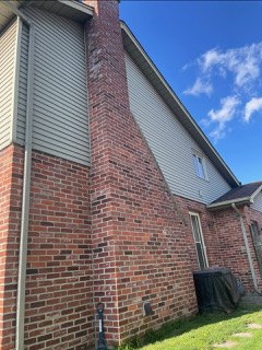Chimney repair detail showing restored joints, cap area, and clean finish